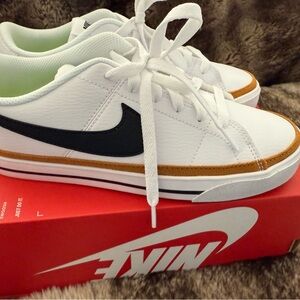 Nike White Sneakers with Black Swoosh and Gold Trim